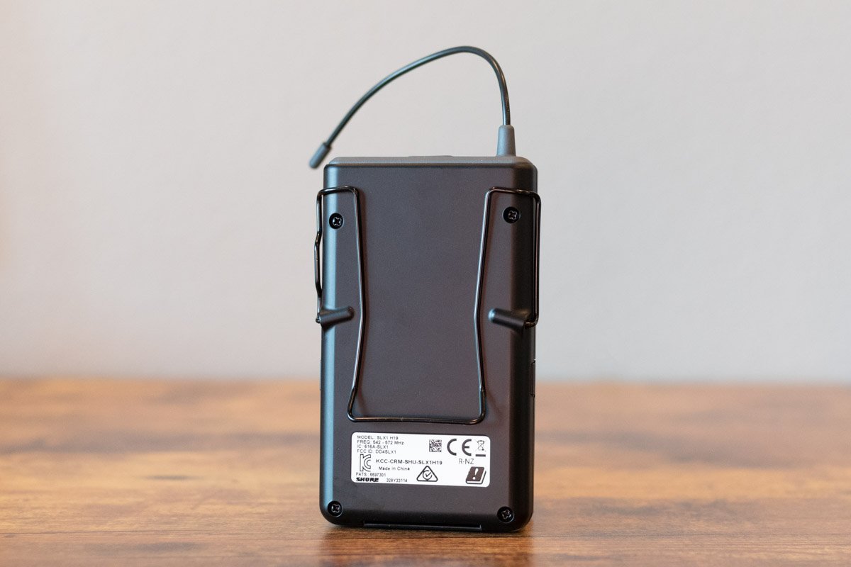 Black electronic device on a wooden surface with a neutral background