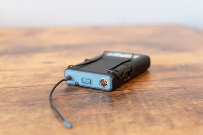 Small electronic device with a cable on a wooden surface