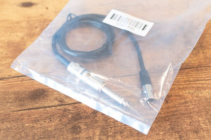 Cable in clear plastic packaging on a wooden surface