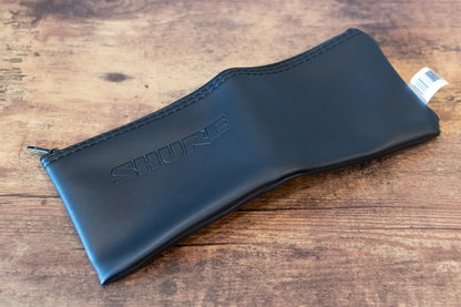 Black Shure case on a wooden surface